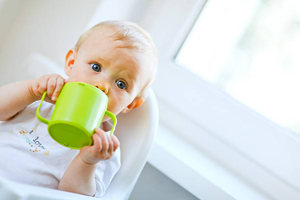 A baby drinking from a cup